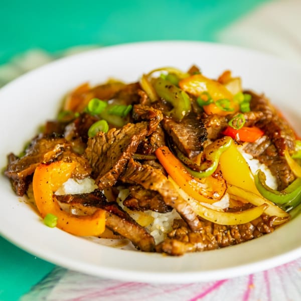 Hula Pizzeria & Grill's beef stir-fry with colorful bell peppers, onions, and rice.